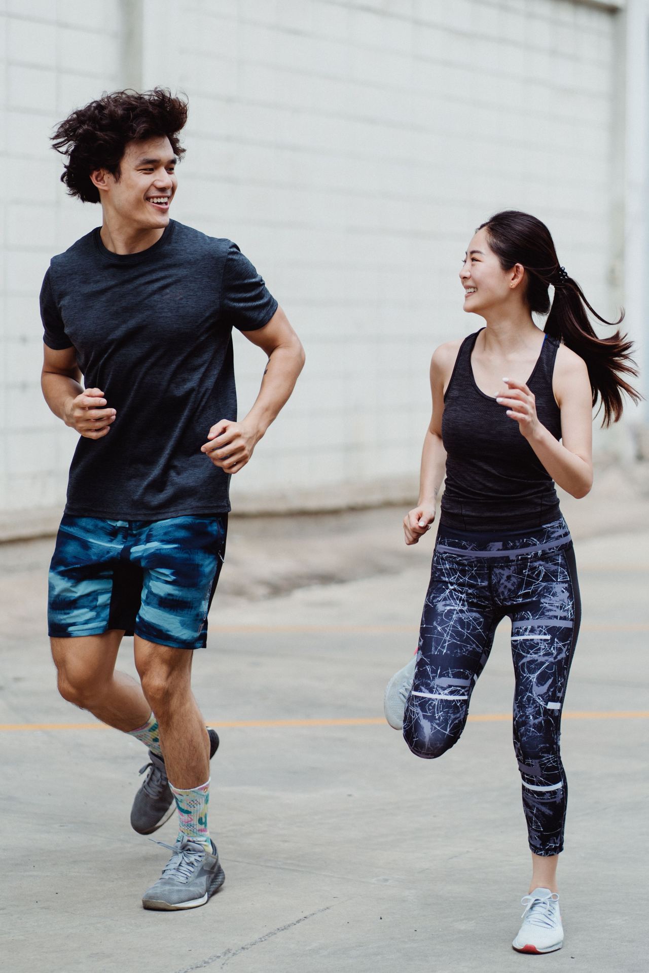 Two people running together outdoors